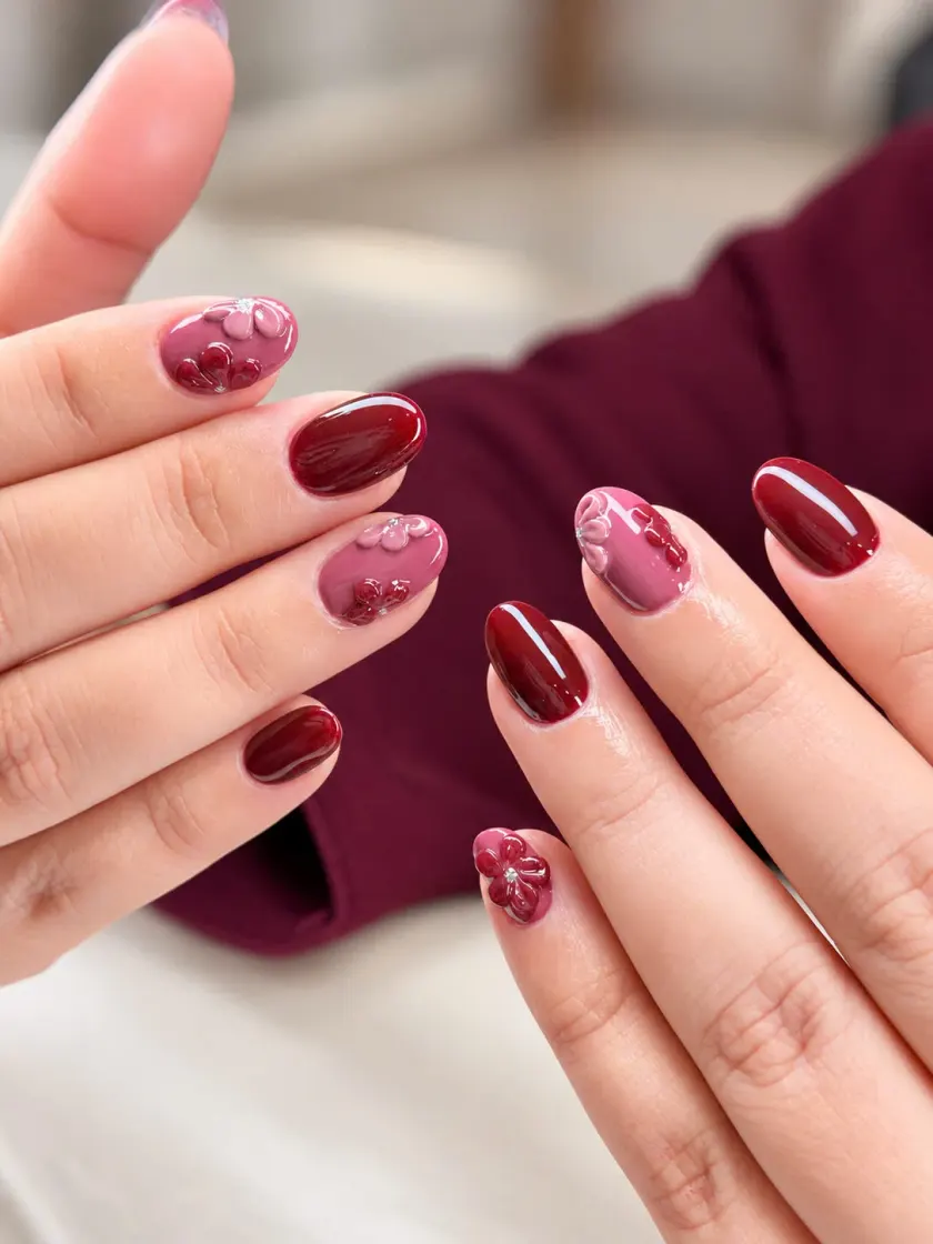 Burgundy gel manicure with pink floral nail art